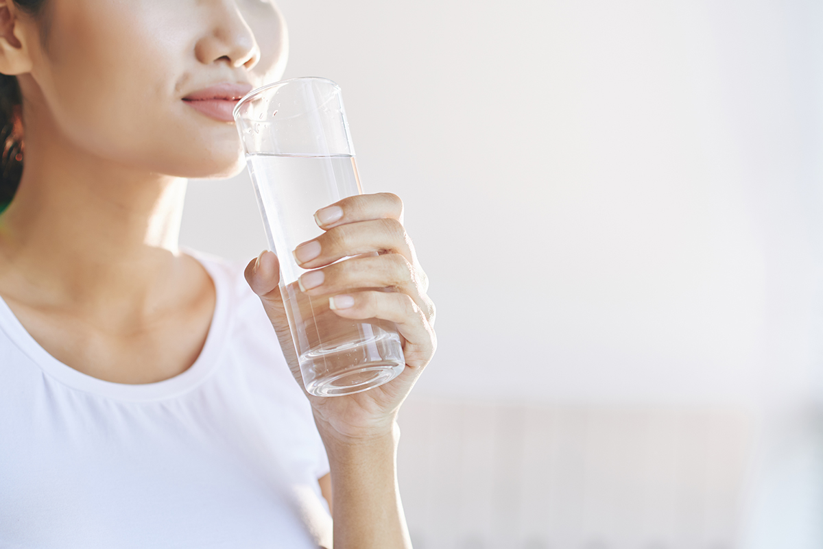 This is an image of a woman drinking a glass of water.