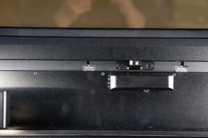 This is an image of inside of an xTool P2 laser machine. It has a sticker above the screw that says unscrew me.