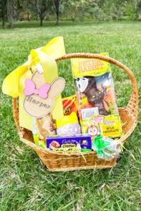 This is an example of one of the free Easter basket tag SVG files completed using a laser machine. The tag is a girl bunny head with a bow that says Harper and is hanging from a basket.