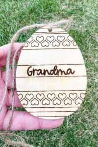 This image shows one of the Easter basket tags made out of wood using an xTool laser machine. It's in the shape of an egg with the name Grandma on it.