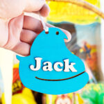 This image shows one of the Easter basket tags made out of wood using an xTool laser machine. It's in the shape of a blue peep chick with the name Jack on it.