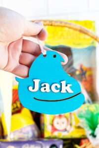 This image shows one of the Easter basket tags made out of wood using an xTool laser machine. It's in the shape of a blue peep chick with the name Jack on it.