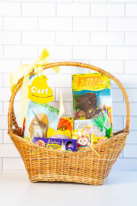 This is an example of one of the free Easter basket tag SVG files completed using a laser machine. The tag is a yellow peep that says Carl and is hanging from a basket.
