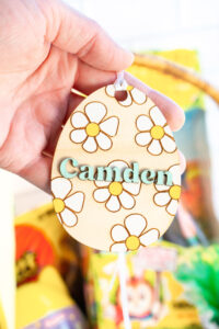 This image shows one of the Easter basket tags made out of wood using an xTool laser machine. It's in the shape of an egg with the name Camden.