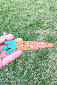 This image shows one of the Easter basket tags made out of wood using an xTool laser machine. It's in the shape of a carrot with the name Jessica on it.