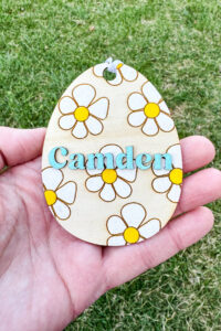This image shows one of the Easter basket tags made out of wood using an xTool laser machine. It's in the shape of an egg with the name Camden.