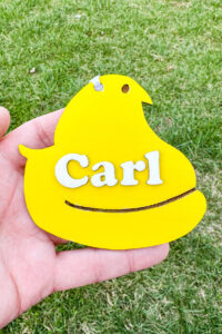 This image shows one of the Easter basket tags made out of wood using an xTool laser machine. It's in the shape of a peep with the name Carl.