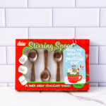 This is one of the free Christmas treat gift tags you can download in this post. It says, You’re Worth Melting For. It features a marshmallow snowman soaking in hot cocoa in a mug with some cookies and treats surrounding the mug. The tag is attached to a box of chocolate spoons.