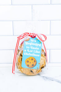 This is one of the free Christmas treat gift tags you can download in this post. It says, It’s Beginning to Taste a Lot Like Christmas. It features a chocolate chip cookie and a few chocolate chip cookie crumbs. The tag is attached to a small bag of chocolate chip cookies.