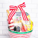 This is one of the free Christmas treat gift tags you can download in this post. It says, Baking Spirits Bright featuring Christmas cookies and baking supplies. It is attached to a gift basket filled with Christmas baking supplies, a Christmas red and white stripped rolling pin, and a red and green spatula.