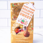 This is one of the free Christmas treat gift tags you can download in this post. It says, Hope Your Holiday Season is Sweet. This fag features a gingerbread man and other sweet Christmas treats. The tag is attached to a bag of Lindor Lindt Truffles.