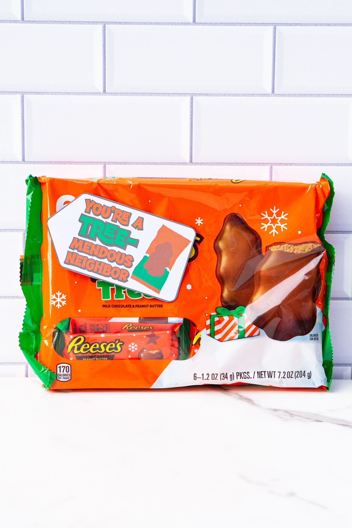 This is one of the free Christmas treat gift tags you can download in this post. It says, You’re a Tremendous Teacher. This version of the tag features the Reese’s Peanut Butter Tree. The tag is attached to a pack of Reese’s Peanut Butter trees.