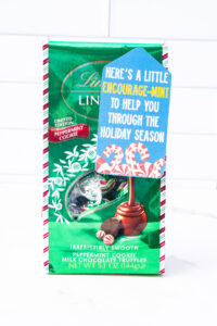 This is one of the free Christmas treat gift tags you can download in this post. It says, Here’s a Little Encourage-Mint. At the bottom it has some candy canes and peppermints. The tag is attached to a bag of Lindt Mint Cookie chocolates.