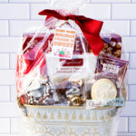 This is one of the free Christmas treat gift tags you can download in this post. It says, Hope Your Holiday Season is Sweet. This fag features a gingerbread man and other sweet Christmas treats. The tag is attached to a gift basket filled with holiday treats.