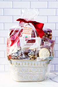 This is one of the free Christmas treat gift tags you can download in this post. It says, Hope Your Holiday Season is Sweet. This fag features a gingerbread man and other sweet Christmas treats. The tag is attached to a gift basket filled with holiday treats.