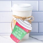 This is one of the free Christmas treat gift tags you can download in this post. It says, You Deserve a Latte Joy this Christmas. It is on a hand drawn coffee cup tag that is red with snowflakes. The tag is attached to a to go cup of coffee.