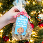 This is one of the free Christmas treat gift tags you can download in this post. It says, It’s Beginning to Taste a Lot Like Christmas. It features a chocolate chip cookie and a few chocolate chip cookie crumbs. The tag is attached to a small bag of chocolate chip cookies.