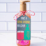 This is one of the free Christmas treat gift tags you can download in this post. It says, Have a Scent-Sational Holiday. It features a candle and a soap pump dispenser. The tag is attached to a Peppermint Twist hand soap container.