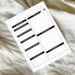 Dream log printable placed on soft, cream-colored fabric, showing clean black-and-white sections for dream details, interpretation, and notes.