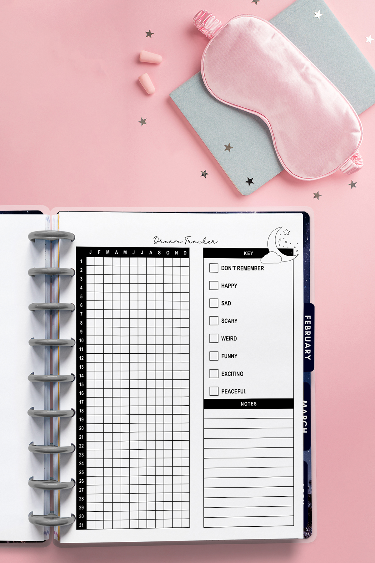 Dream tracker inserted into a discbound planner, photographed on a pink background with a sleep mask, earplugs, and scattered star confetti.