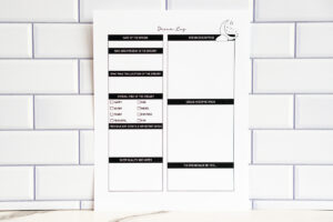 Single printed dream log page displayed against a white subway-tile background, showing sections for dream details, vibe checkboxes, notes, sleep quality, and interpretation.