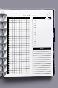 Close-up of the dream tracker page inside a discbound planner, showing the grid for all 12 months, key checkboxes, and notes area.