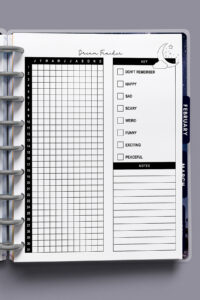 Close-up of the dream tracker inside a discbound planner, showing the full grid, key checkboxes, and spacious notes area.