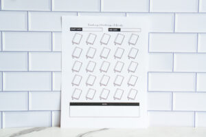 A printable &ldquo;Reading Challenge: 25 Books&rdquo; sheet with 25 blank book icons, start and end date boxes, and a notes section at the bottom, shown against a white tile backdrop.