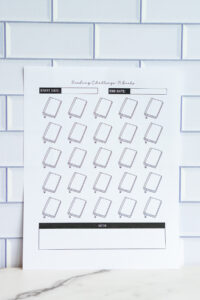 A close-up vertical photo of a &ldquo;Reading Challenge: 25 Books&rdquo; printable page with start and end date fields, 25 outlined book icons, and a notes area at the bottom.