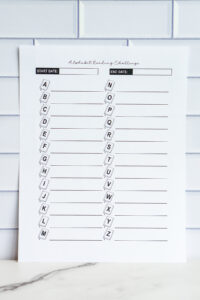 A printable &ldquo;Alphabet Reading Challenge&rdquo; sheet with letters A&ndash;Z on book-shaped icons and blank lines beside each letter for writing book titles, plus start and end date fields.