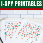 Pinterest graphic titled &ldquo;Free Christmas I-Spy Printables&rdquo; with two colorful I-Spy game sheets shown underneath.