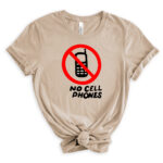 Light beige t-shirt with a red circle-and-slash no-phone graphic above the words “No Cell Phones” in black, styled with rolled sleeves and a front knot.
