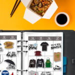 Planner open to a weekly spread decorated with Gilmore Girls stickers, placed on an orange background next to an open takeout container of rice, chopsticks, and a small cup of soy sauce.