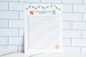 Simple two-column Christmas bucket list printable with checkboxes and festive illustrations, displayed against a white tile background.