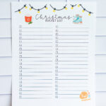 Blank customizable Christmas bucket list printable with two columns of empty checkboxes, hanging Christmas lights, hot cocoa, and ice skates illustrations.