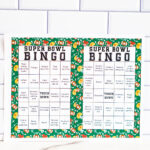 Two bright green Super Bowl Bingo sheets displayed together against a white subway tile wall.