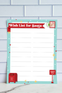 Wish List for Santa printable featuring larger writing lines, turquoise border, festive stars, and red mailbox and North Pole sign graphics.