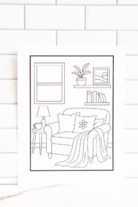 Printable indoor relaxation coloring page showing a cozy reading nook with an armchair, blanket, pillows, lamp, books, and houseplants.