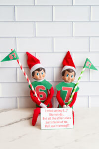 Two elves in 6 and 7 shirts holding &ldquo;67&rdquo; flags, with a printed card that reads, &ldquo;I tried saying 6&hellip;7 like you do&hellip; But all the other elves just stared at me. Did I use it wrong??&rdquo;