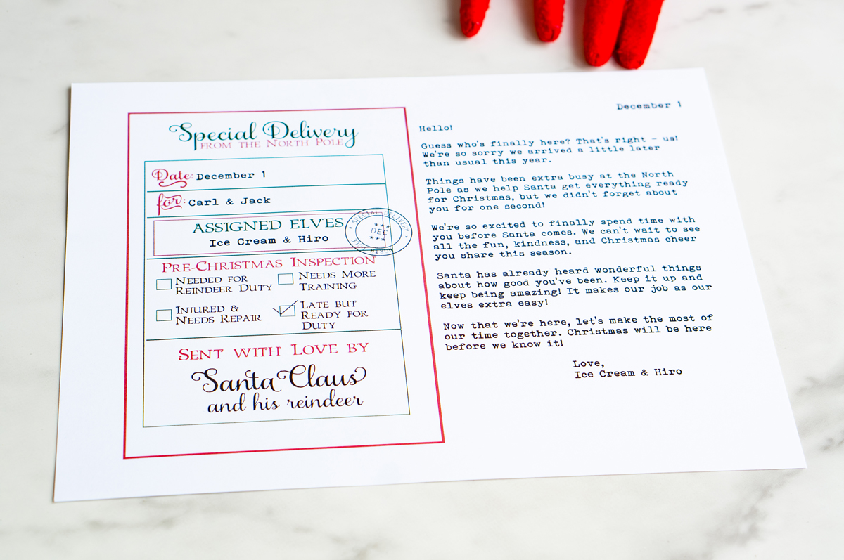A flat-lay of the complete &ldquo;Sorry I&rsquo;m Late&rdquo; North Pole letter and assignment form for Carl and Jack, printed in festive red and green on a marble surface.