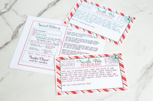 A flat-lay of the full Elf on the Shelf late-arrival kit, including the &ldquo;Sorry I&rsquo;m Late&rdquo; telegram and the customizable letter assigning elves Ice Cream & Hiro.