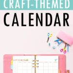 Graphic pin with the text &lsquo;Free Undated Craft-Themed Calendar&rsquo; above an open pink planner showing the September craft-themed calendar, surrounded by colorful scissors, clips, and a pink pencil pouch.