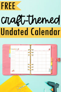 Graphic pin featuring the text &lsquo;Free Craft-Themed Undated Calendar&rsquo; above an open pink planner showing the March craft-themed calendar, styled with yellow fabric, scissors, and a glue gun.