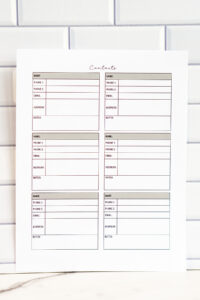A full-page view of a six-box contact card layout printable page. Each box includes labeled sections for name, phone numbers, email, address, and notes, printed in soft neutral tones and photographed against a white subway-tile background.