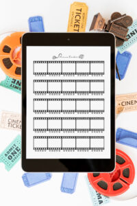 Tablet showing a filmstrip-style movie tracker page, styled with vintage movie reels and colorful cinema tickets around the edges.