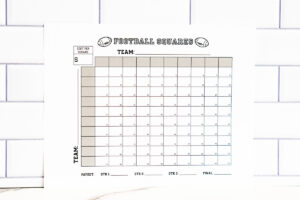 Football squares printable centered against a white subway-tile backdrop, showing the full 100-square grid and payout lines.