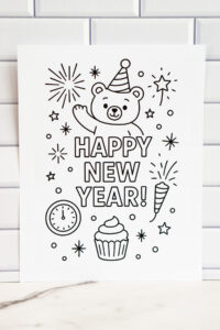 Close-up of the bear-themed &ldquo;Happy New Year&rdquo; coloring page displayed against a white subway-tile background, showcasing fireworks, stars, a clock, a cupcake, and a party horn.
