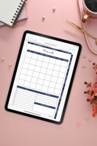 iPad on a pink desk showing the March monthly calendar page from the digital planner, surrounded by a cup of coffee, spiral notebook, flowers, and scattered pearls.
