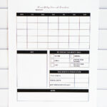 Printed monthly period tracker page shown upright in front of a white subway tile wall. The layout features an empty monthly calendar, symptom checkboxes, a section to mark period timing and quality, monthly stats, and a large notes section.