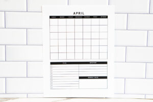 Vertical undated April monthly calendar page with a full grid and additional To Do, Important, and Monthly Focus sections, displayed against a white subway tile backsplash.